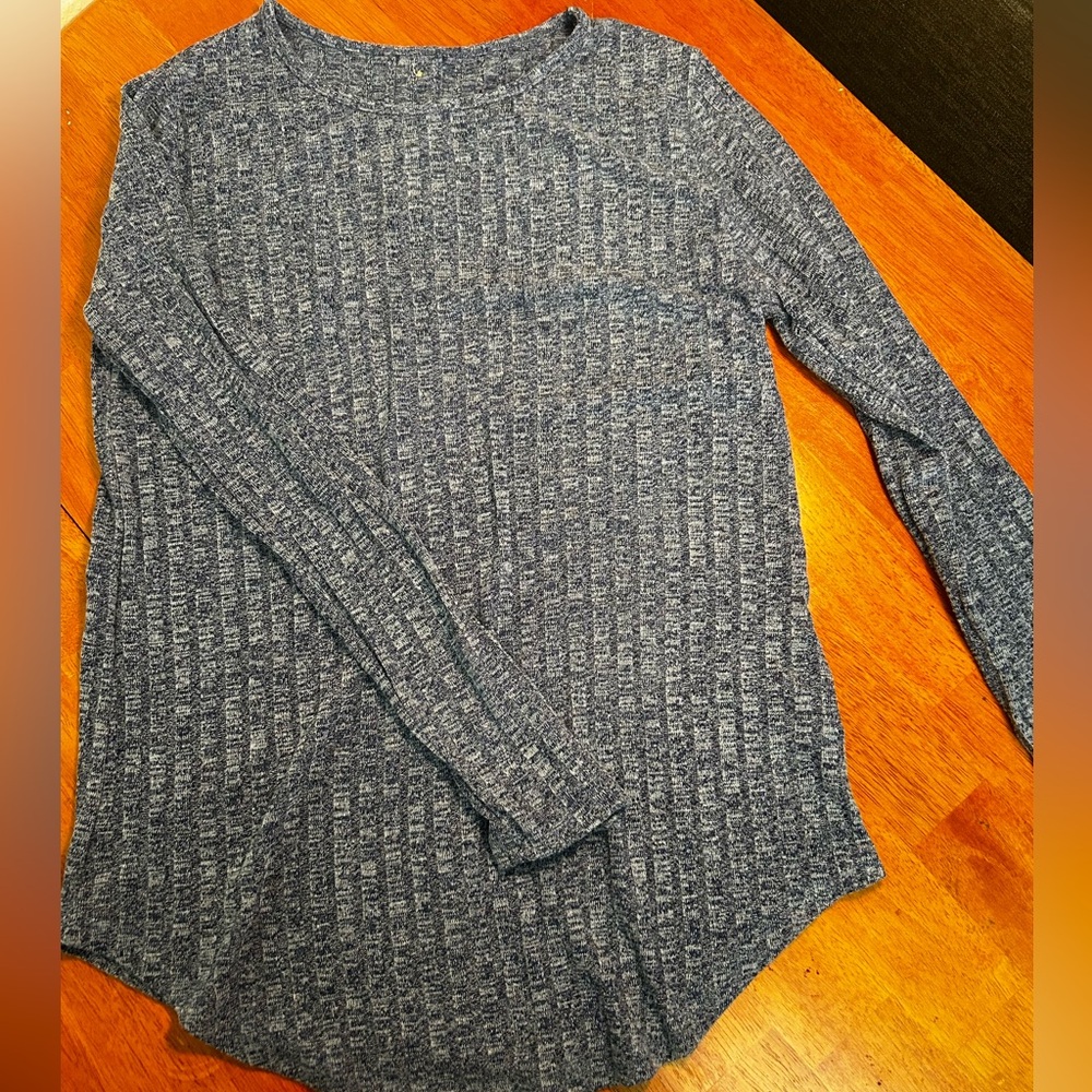 Blue long sleeve top with decorative buttons going down the back